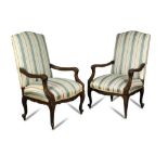 A pair of French Regence style mahogany open armchairs, 20th century, upholstered in a striped