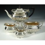 An Edwardian matched silver four piece teaset, comprising:- a teapot by William Aitken, Birmingham