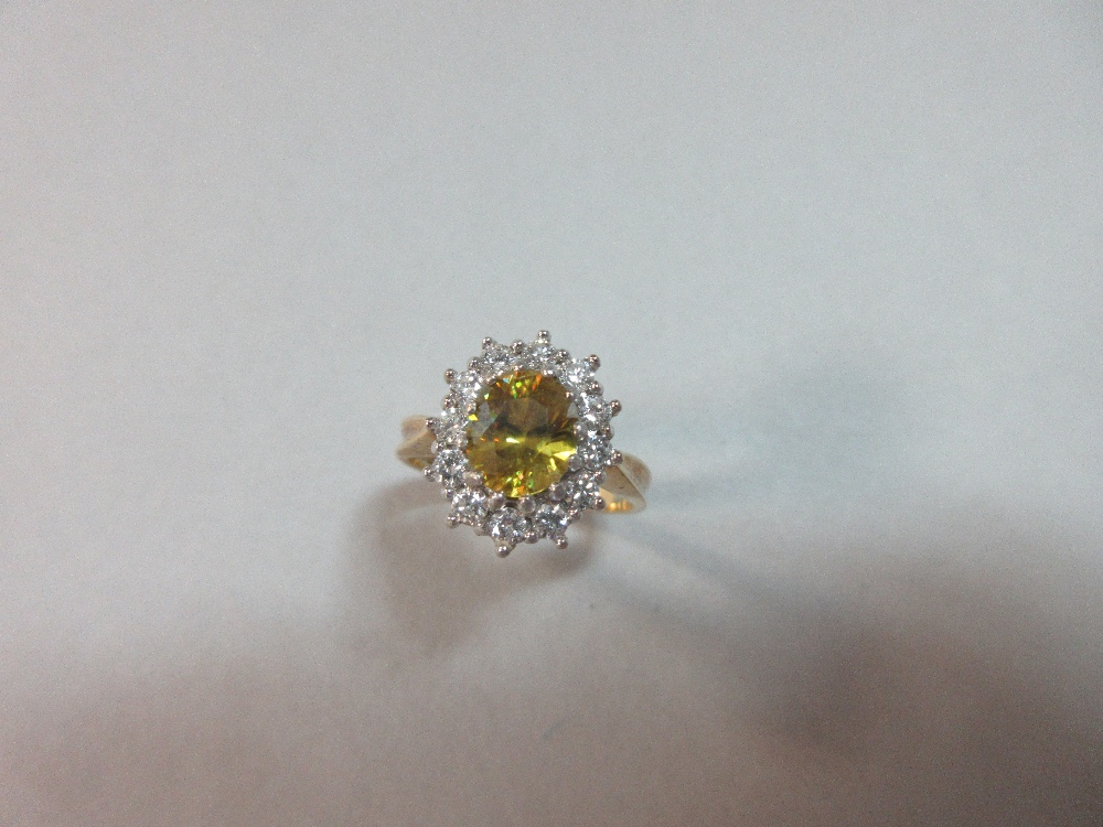 A golden sphene and diamond cluster ring set in 18ct gold, the oval cut sphene of intense slightly - Image 2 of 6