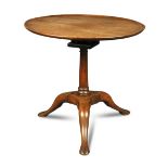 A George II mahogany tripod table, with a birdcage support and tray edge circular top, on three legs
