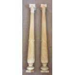 A pair of carved wood classical columns, the tapering fluted columns with Ionic capitals 140cm (