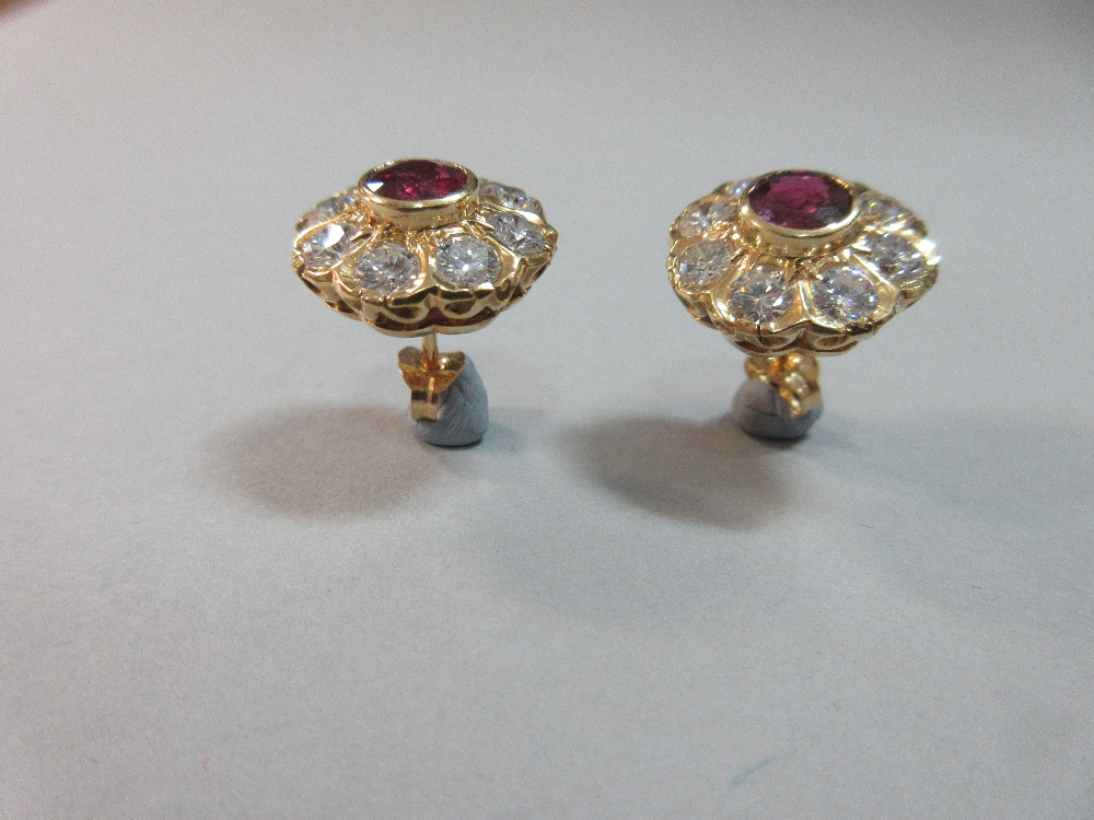 A pair of rhodolite and diamond flowerhead earstuds, each round cut rhodolite garnet collet set in a - Image 2 of 7