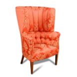 A mahogany wing back armchair, late 18th century, the barrel back upholstered in a red damask