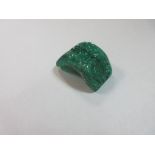 A large semi-circular carved emerald, the domed band of uniform width (2.8cm) and tapered thickness,