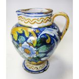 An Italian Majolica jug, probably 18th century, of shouldered ovoid form on spreading circular base,