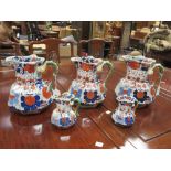 Five 19th century imari jugs with biting snake handles