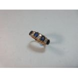 An Edwardian sapphire and diamond ring, set with four oval cut sapphires separated by pairs of old