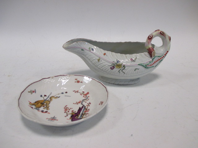 An 18th century Worcester leaf moulded sauce boat, painted with floral sprigs, 23cm (9in) long; a