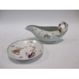 An 18th century Worcester leaf moulded sauce boat, painted with floral sprigs, 23cm (9in) long; a