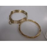 A five bar gate bracelet stamped 18k (13.7g) together with gold hinged bangle stamped 585 (12.5g) (