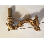 A pair of 19th century Italian gilt gesso wall lights, each with scrolling arm and now converted