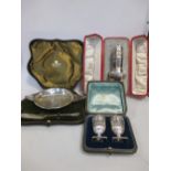 A group of cased silver items to include a caster, by The Goldsmiths & Silversmiths Co Ltd