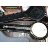 A four string banjo by John Grey & Sons London, coloured Persian style back, some signs of use/