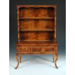 An early 20th century burr yew wood miniature dresser, the plate rack above a frieze of three