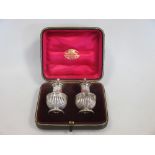 A cased pair of silver pepper casters by The Goldsmiths & Silversmiths Co Ltd, London 1924