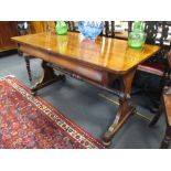 A 19th century rosewood library table with two frieze drawers, on end supports with stretcher, 137cm