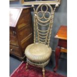 A cane work chair, with a high trefoil back