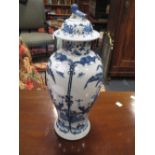 A Chinese blue and white baluster shape vase and cover, chip to rim, with Kang Hsi style four