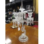 A three light candelabrum supported by a frosted glass dolphin, 60 cm high