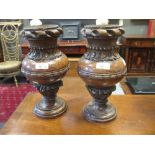 A pair of carved walnut vases (2)