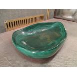 A rough formed malachite dish