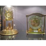 A Rotary pendulum clock under glass dome and a battery operated clock (2)
