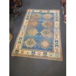 A large Kazak style carpet, 321 x 215cm (worn)