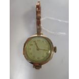 A lady's 9ct cased wristwatch with an associated strap,