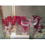 A quantity of assorted cranberry glass, to include a pair of lustres and vases