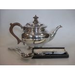 A silver teapot, pair of George III table spoons and a cased teaspoon