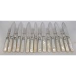 A eight pairs of mother of pearl handled steel dessert knives and forks with silver ferrules