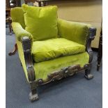 A 1930's Jacobethan club chair with green upholstery raised on braganza feet.