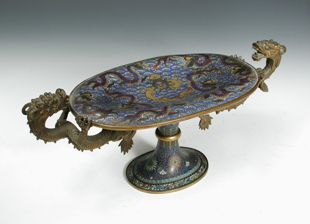 A late 19th /early 20th century cloisonne two handled tazza, two gilt dragon handles clasping the
