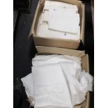 Two boxes of assorted plain and damask table cloths, table runners and napkins etc.