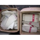 Two boxes of assorted household linen to include basin cloths, hand towels in cream, white and