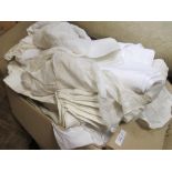 A large quantity of white damask table clothes, assorted napkins and assorted house hold linens