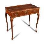 A mahogany silver table, with shallow gallery top and single drawer, pierced brass handles, on