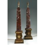 A pair of gilt mounted rouge marble table lamps, the obelisk columns on square section plinth base