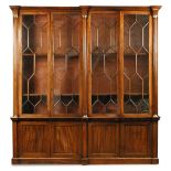 A 19th century mahogany library bookcase, with astragal glazed doors above, divided by brass mounted