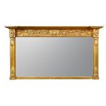 A late Regency gilt framed overmantle mirror, with foliate scroll moulded frieze and column sides