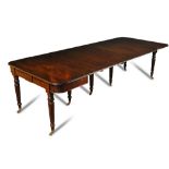 An early 19th century mahogany extending dining table, with concertina action, four additional