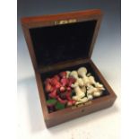 A carved ivory Staunton pattern chess set, the stained red and white pieces within a mahogany box,