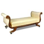 A Regency simulated rosewood day bed, with scrolling ends, on swept legs, brass lion paw feet and