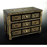 An early 19th century Continental miniature ebony and ivory inlaid chest of drawers, the three