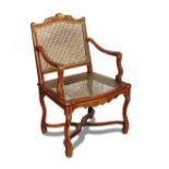 A Regence revival red and gilt painted frame chair, the cane back and seat on stretchered supports