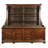 An 18th century oak dresser, with boarded back, fluted column sides above a base of fitted drawers