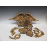 A carved giltwood eagle cresting and other assorted crestings