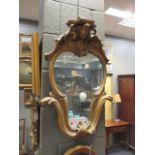 A 19th century gilt wood pier mirror with shelf crested top, 72cm high