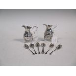 A George III silver cream jug, another & various silver teaspoons