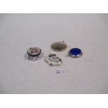 A silver and blue enamel compact and a silver gilt compact, an enamelled Brandy label and an